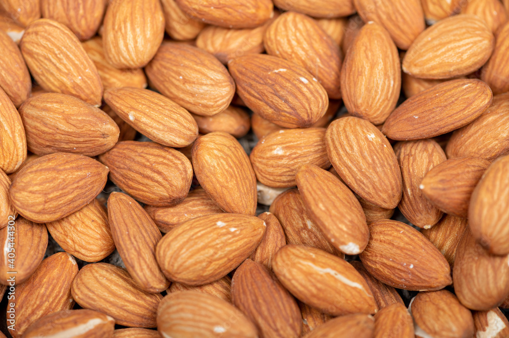 Almonds scattered on the table. Close-up, selective focus. Almonds scattered on the table. Close-up, selective focus.