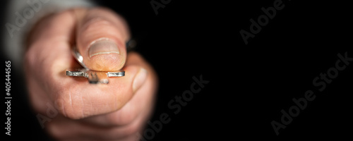 Front view of hand with key and black background