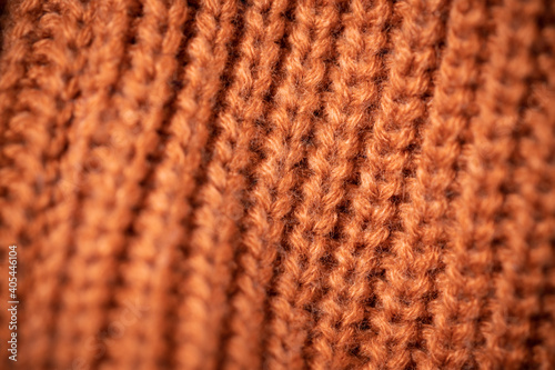 Orange wool scarf background texture. Macro photo with selective focus.