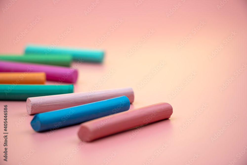 lots of colorful crayons on a pink background lots of colorful crayons on a pink background