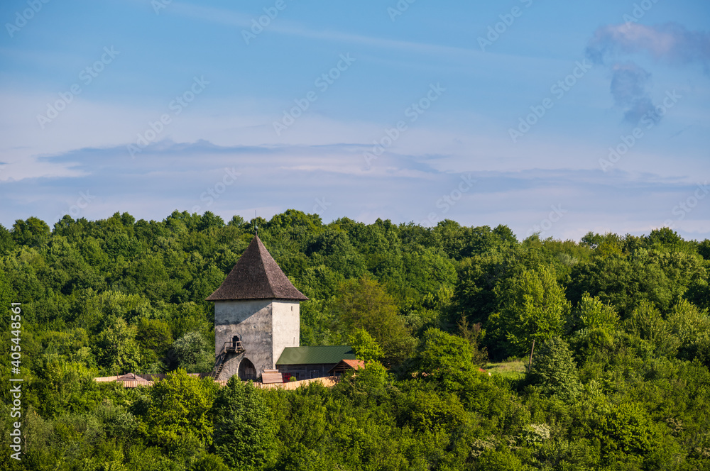 Pyatnychany tower (defense structure, 15th century) on forest hill slope, Lviv Region, Ukraine.