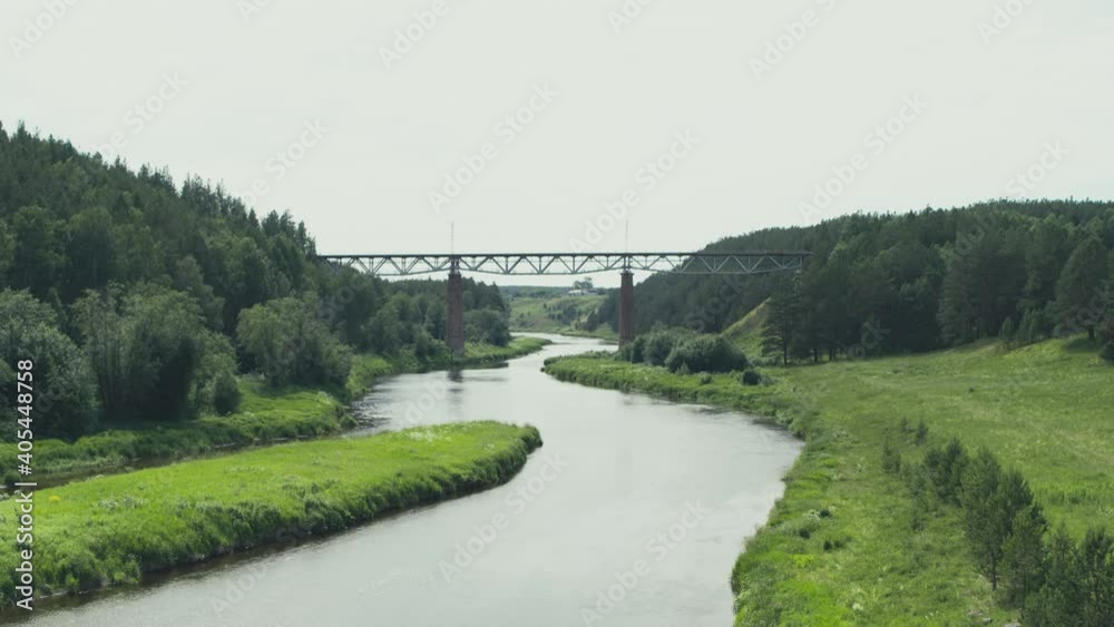 Aerial view of the railway bridge over the river in the forest Aerial view of the railway bridge over the river in the forest