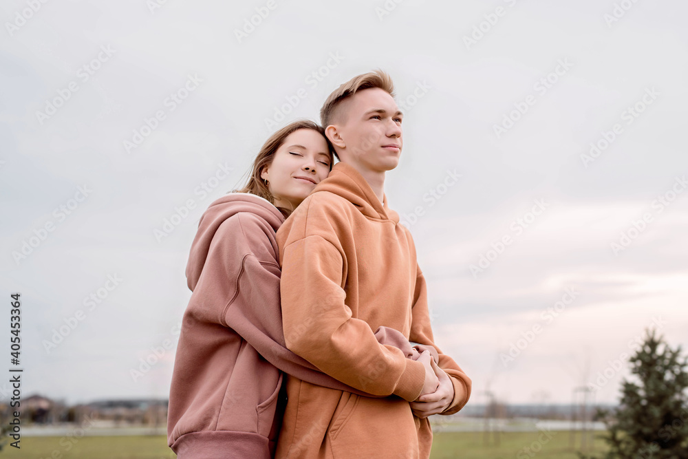 Young loving couple embracing each other outdoors in the park Young loving couple embracing each other outdoors in the park