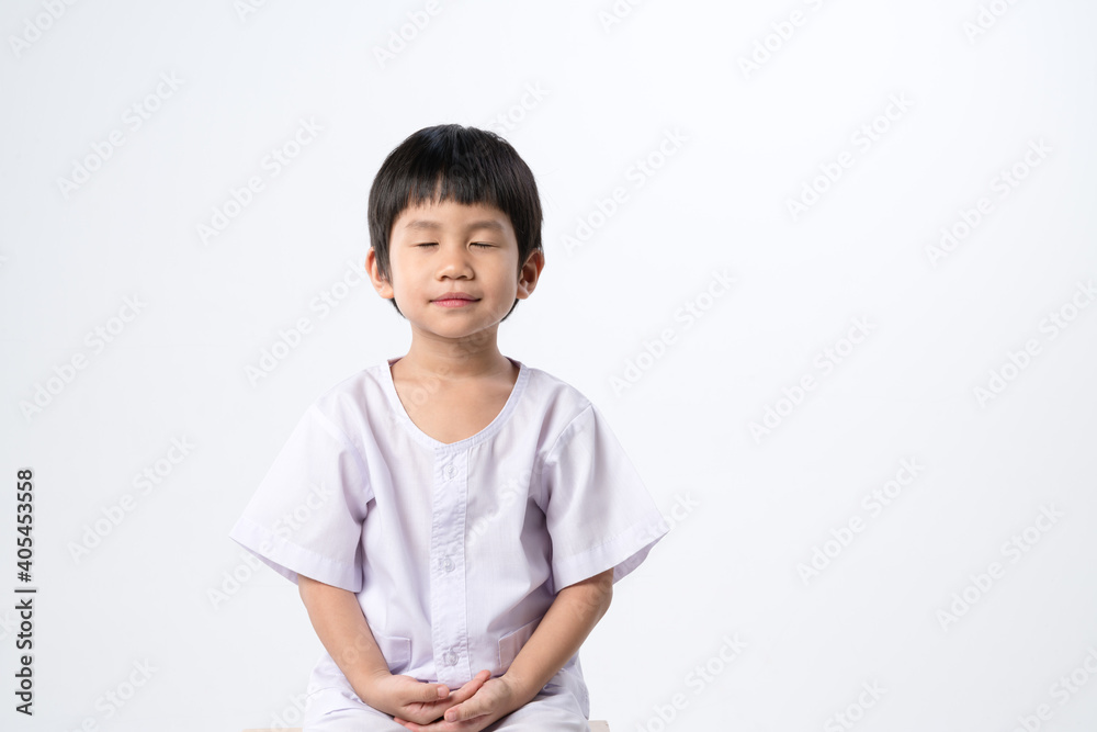 Asian boy in white dress for practice meditation Asian boy in white dress for practice meditation