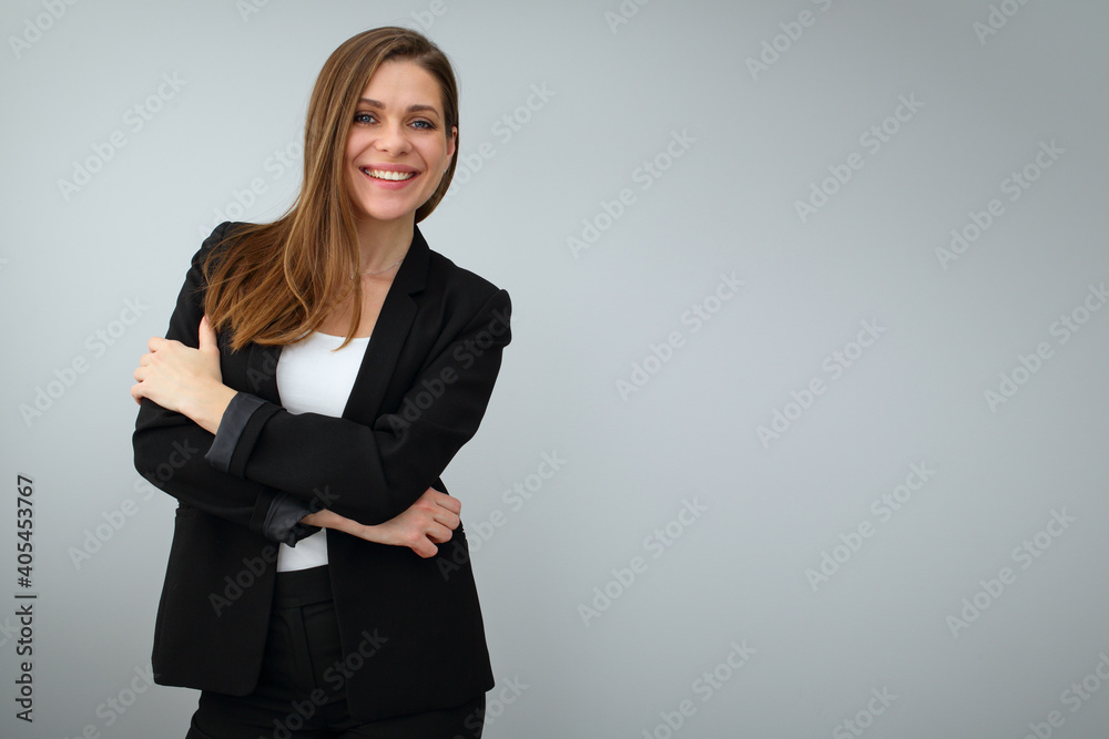 Smiling business woman wearing black suit standing with crossed arms. Smiling business woman wearing black suit standing with crossed arms.