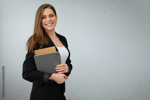 Woman teacher wearing black business suit holding work book. photo