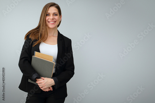 Woman teacher wearing black business suit holding work book.