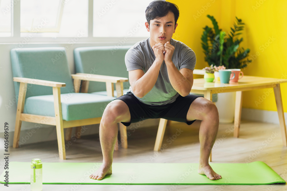 Asian man doing exercise at home Asian man doing exercise at home