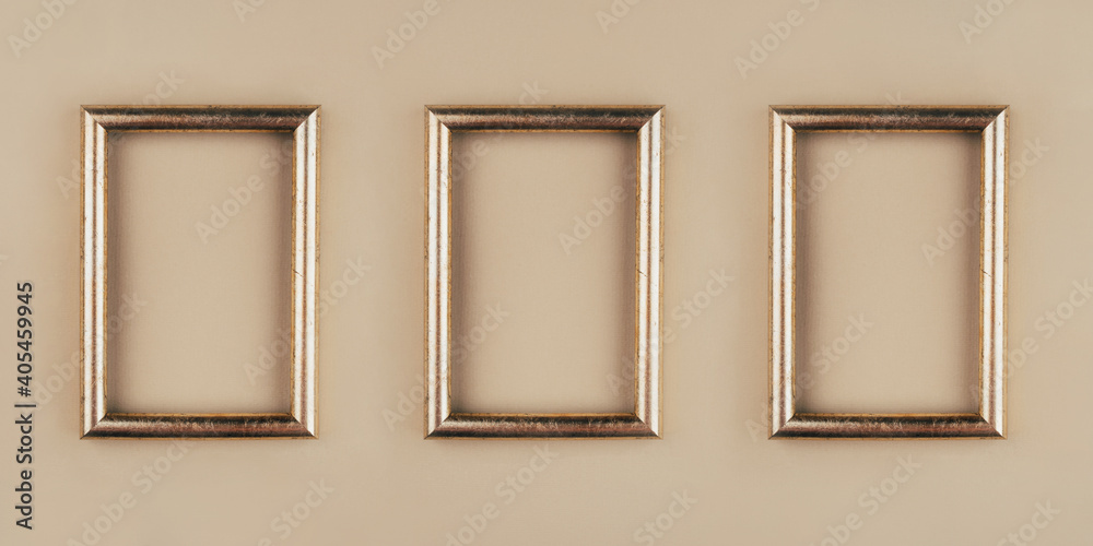 Gold text frames on a beige background. Copy space for text. Gold text frames on a beige background. Copy space for text.