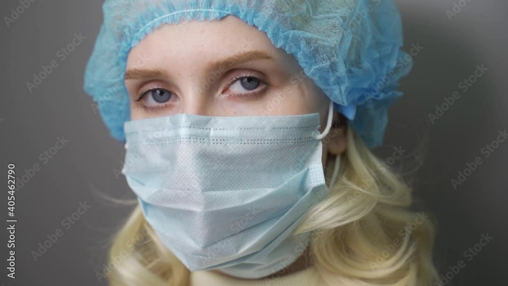 sad and tired medic opens eyes and looking atraight at camera. medical stuff portrait closeup. sad and tired medic opens eyes and looking atraight at camera. medical stuff portrait closeup.