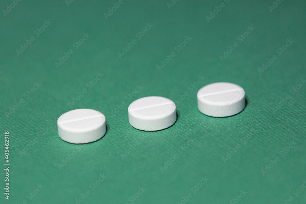 close up. three tablets on a green background. close up. three tablets on a green background.