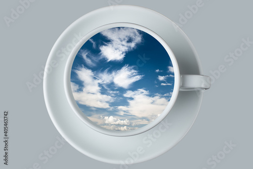 blue sky and white clouds reflected in a white coffee cup on a light background. collage of two images.