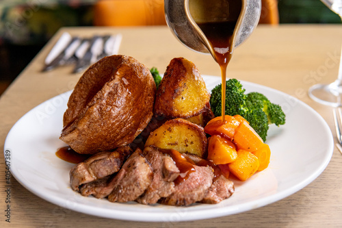 Gravy being poured on roast dinner 