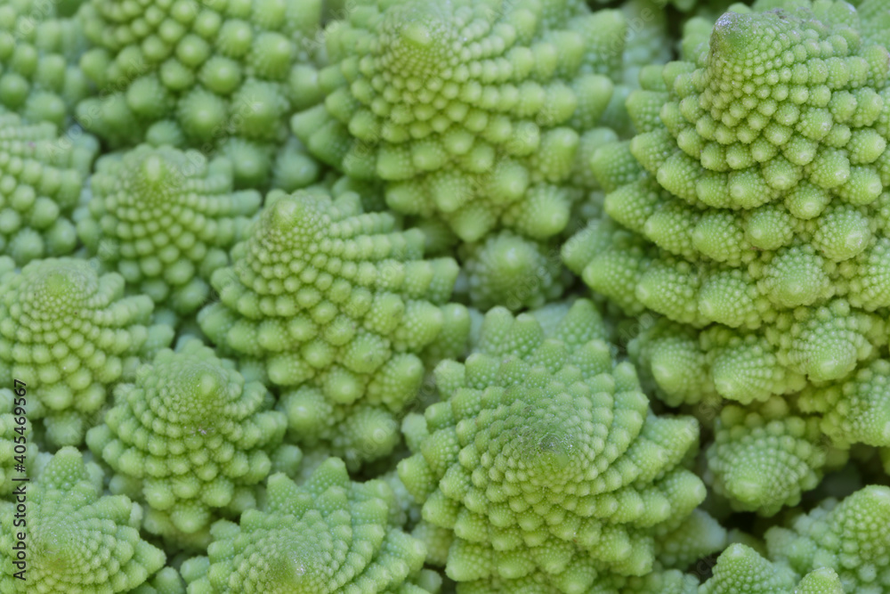 Close-up of natural fractals of Romanesco broccoli (also known as Roman cauliflower, Broccolo Romanesco, Romanesque cauliflower or simply Romanesco). Viewed from above, abstract full frame photo. Close-up of natural fractals of Romanesco broccoli (also known as Roman cauliflower, Broccolo Romanesco, Romanesque cauliflower or simply Romanesco). Viewed from above, abstract full frame photo.