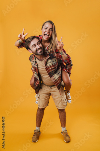 Young happy couple playing together piggyback