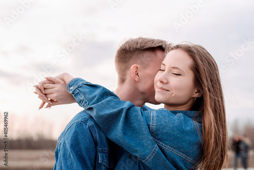 Young loving couple embracing each other outdoors in the park
