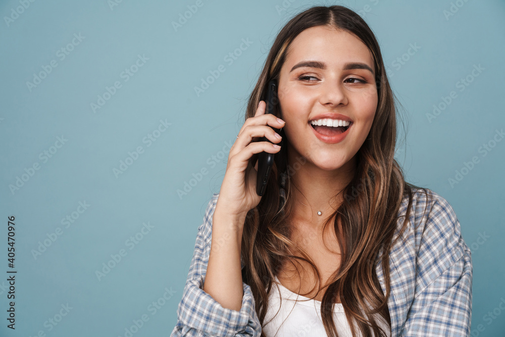 Beautiful young girl in casual wear using mobile phone Beautiful young girl in casual wear using mobile phone