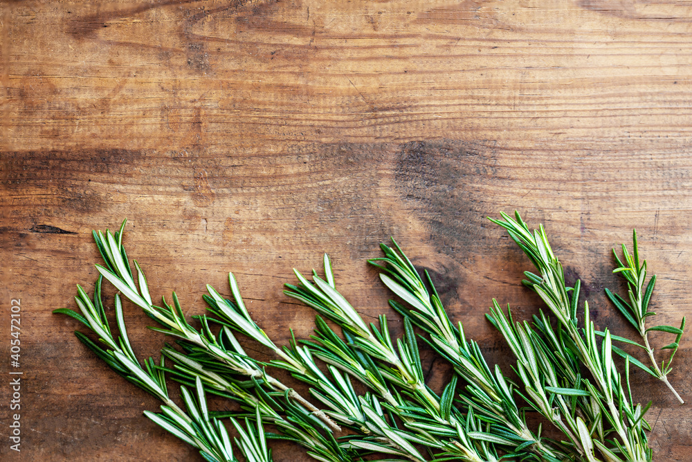 Fresh rosemary herb on a wooden board. Top view rosemary with copy space.. Fresh rosemary herb on a wooden board. Top view rosemary with copy space..