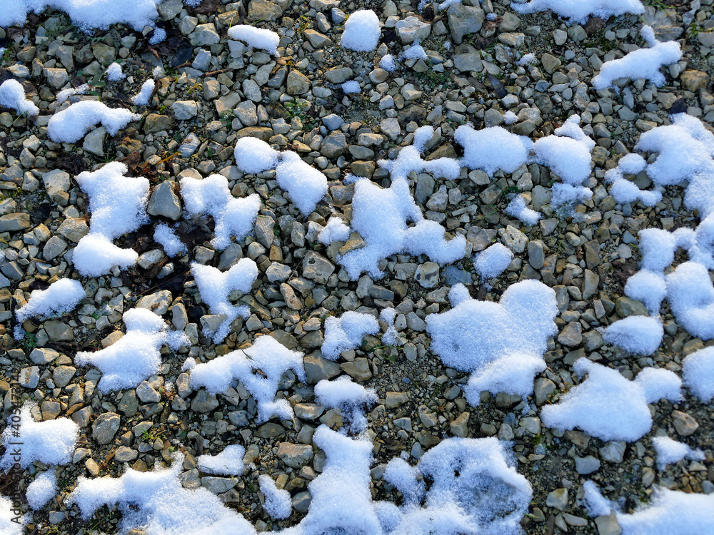 snow residues on pebbles in winter in Germany