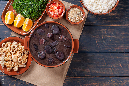 Typical Brazilian dish called Feijoada. Made with black beans, pork and sausage. Top view. Copy space