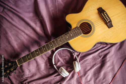 Headphones and classical guitar in bed