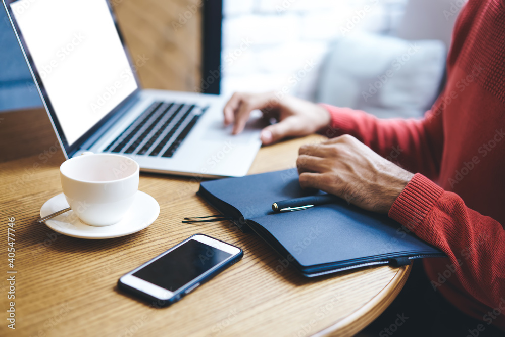 Entrepreneur browsing laptop while sitting on coffee break Entrepreneur browsing laptop while sitting on coffee break