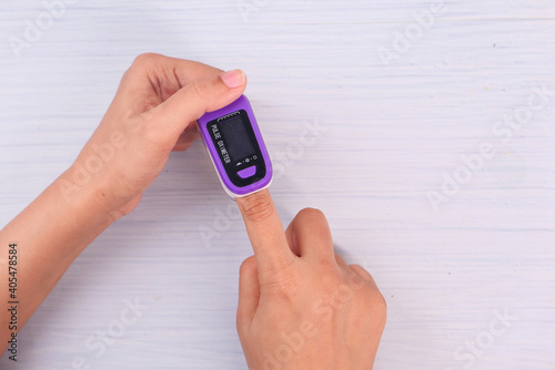  young women hand using pulse oximeter