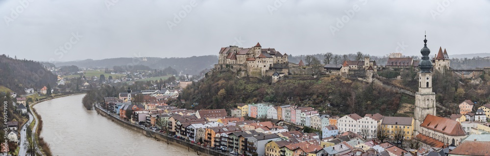 Panoramic view of Burg zu Burghausen, world's longest castle complex on hill along river during rainy days in Burghausen, Germany
