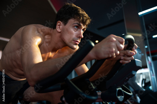 Men workout ride a bike in gym