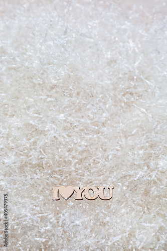 The phrase I love you made of wood on a light background with copy space. Minimalistic valentine's day concept