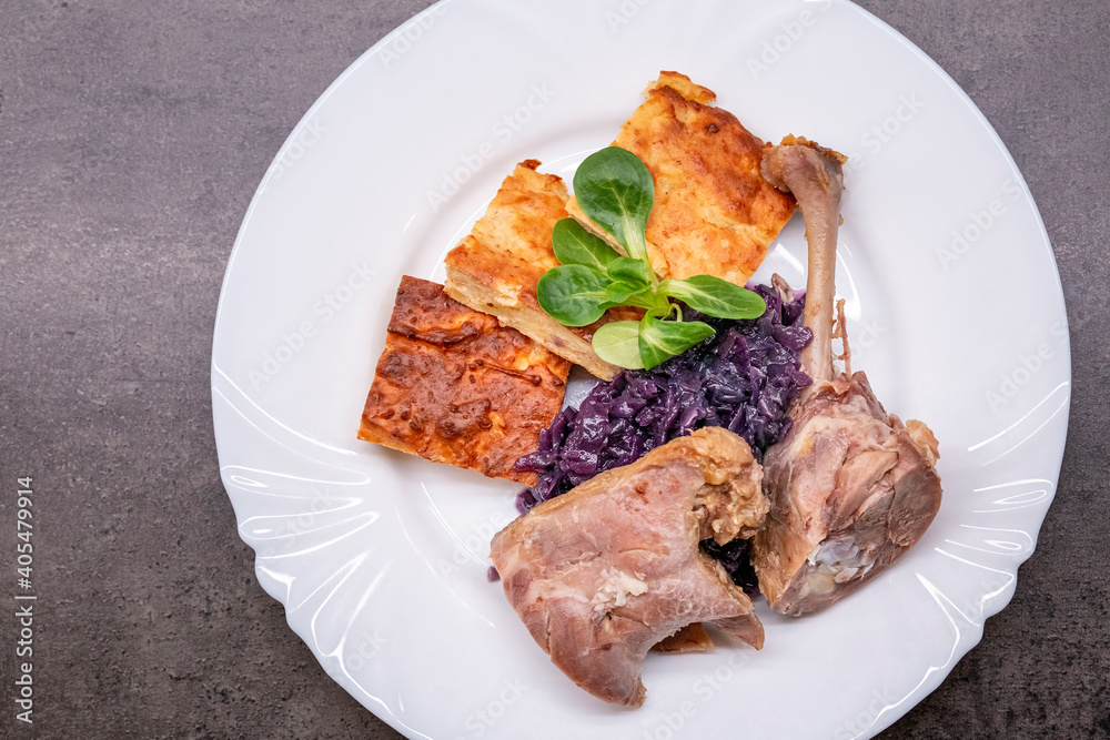 Roasted duck leg with red cabbage and potato pancake, light version. Healthy eating