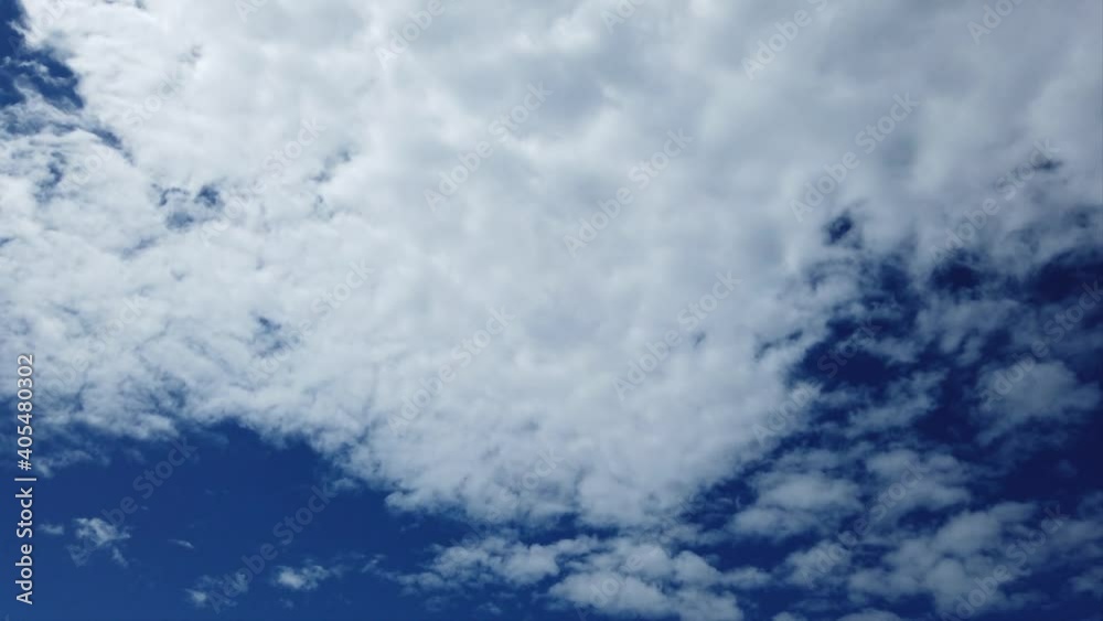 Fantastic summer time lapse with white evanescent cirrus and cumulus clouds and blue sky background