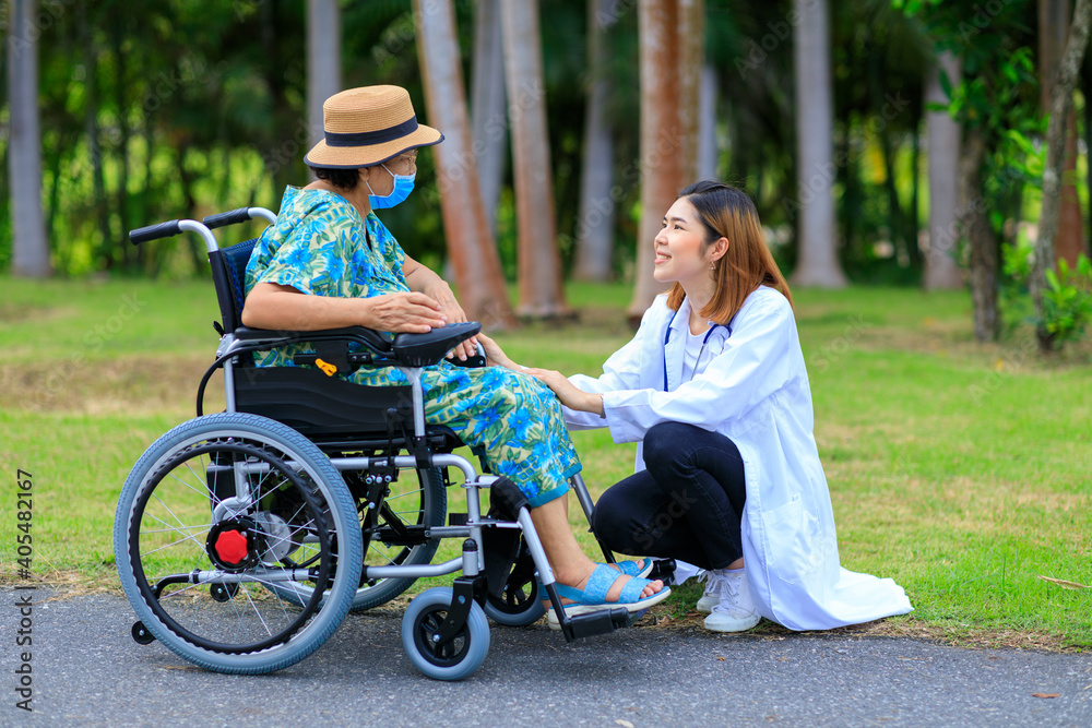 Asian female doctor take care of older patient how to use the electric wheelchair. Asian female doctor take care of older patient how to use the electric wheelchair.