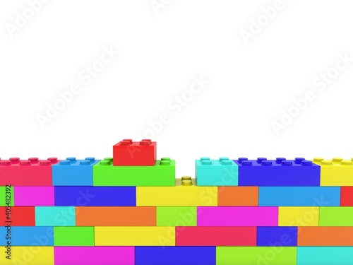 Colored toy bricks in an unfinished wall