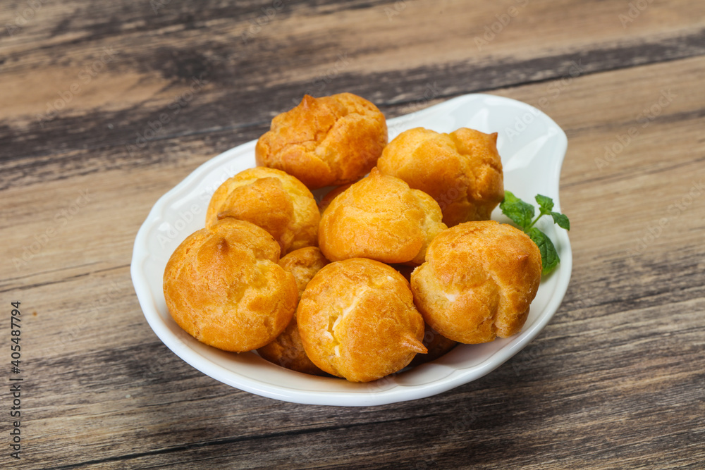 Sweet tasty profiteroles heap in the bowl Sweet tasty profiteroles heap in the bowl