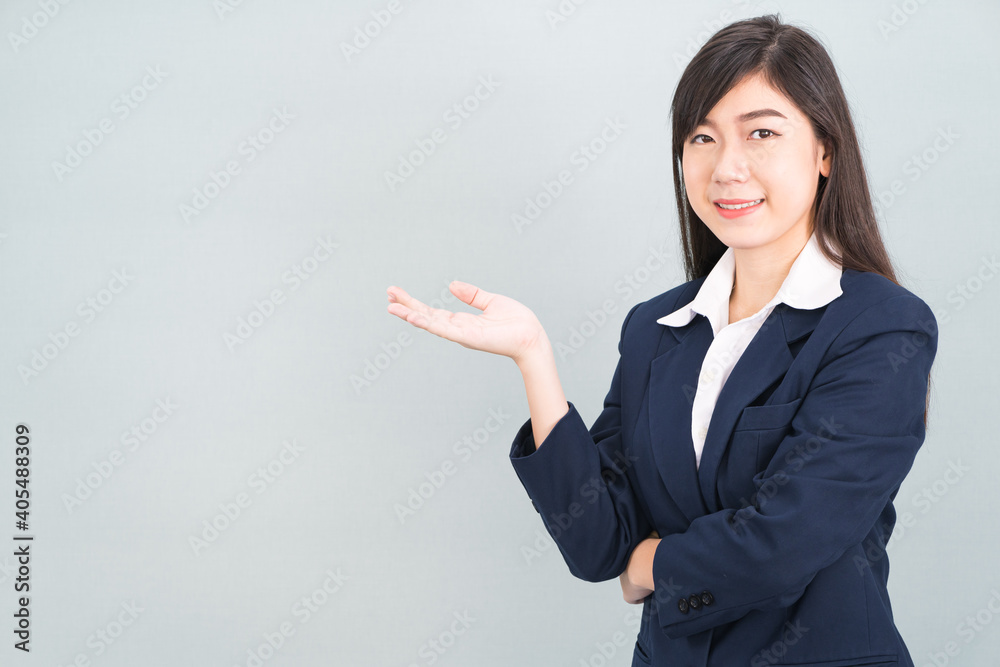 Asian woman in suit open hand palm gestures with empty space Asian woman in suit open hand palm gestures with empty space
