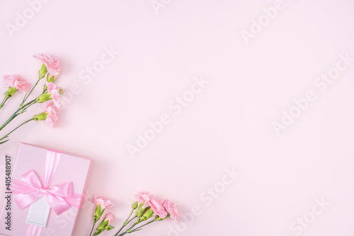 Mother's day design concept of pink carnation and gift box on pink background
