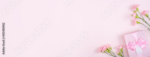 Mother's day design concept of pink carnation and gift box on pink background © RomixImage