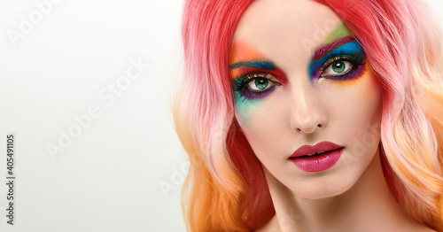 Beauty Fashion woman with Colorful Bright Art Makeup  Pink Dyed Hairstyle. Girl with blue eyes  stylish hair  make up. Beautiful model portrait  fashionable color trend creative make-up.