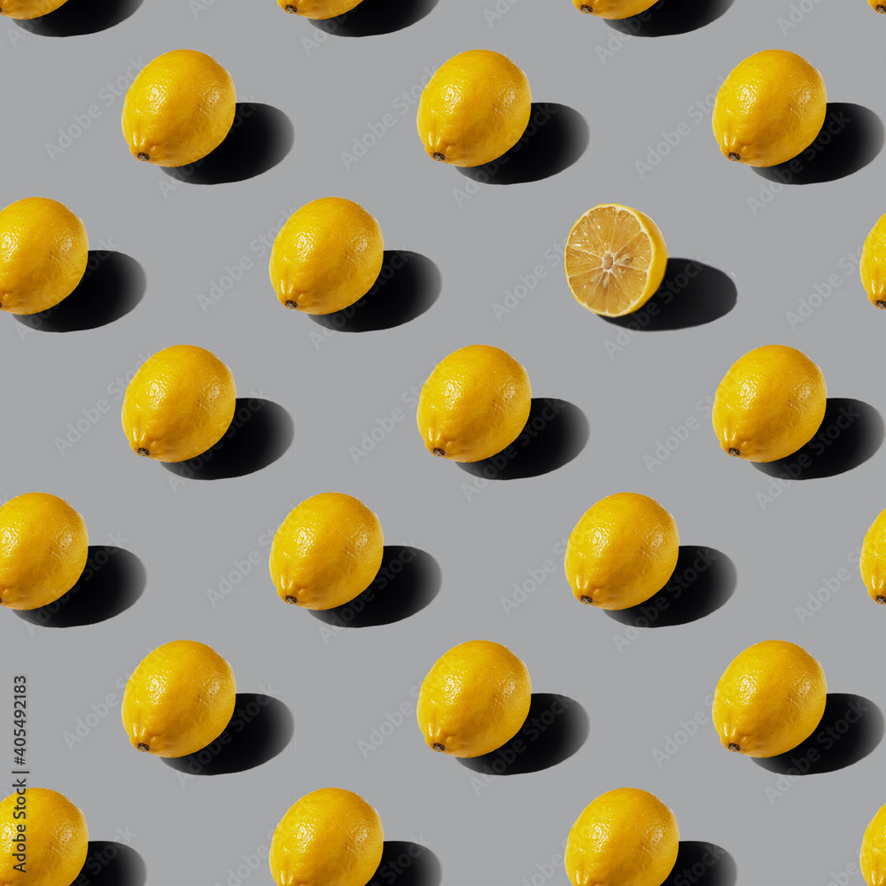 A pattern of whole lemons on a gray background. Healthy food concept. Flat lay. A pattern of whole lemons on a gray background. Healthy food concept. Flat lay.