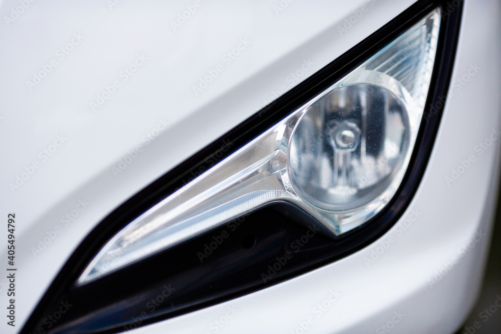white car headlight close up