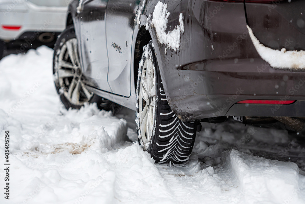 car tires on winter road covered with snow, close-up car tires on winter road covered with snow, close-up