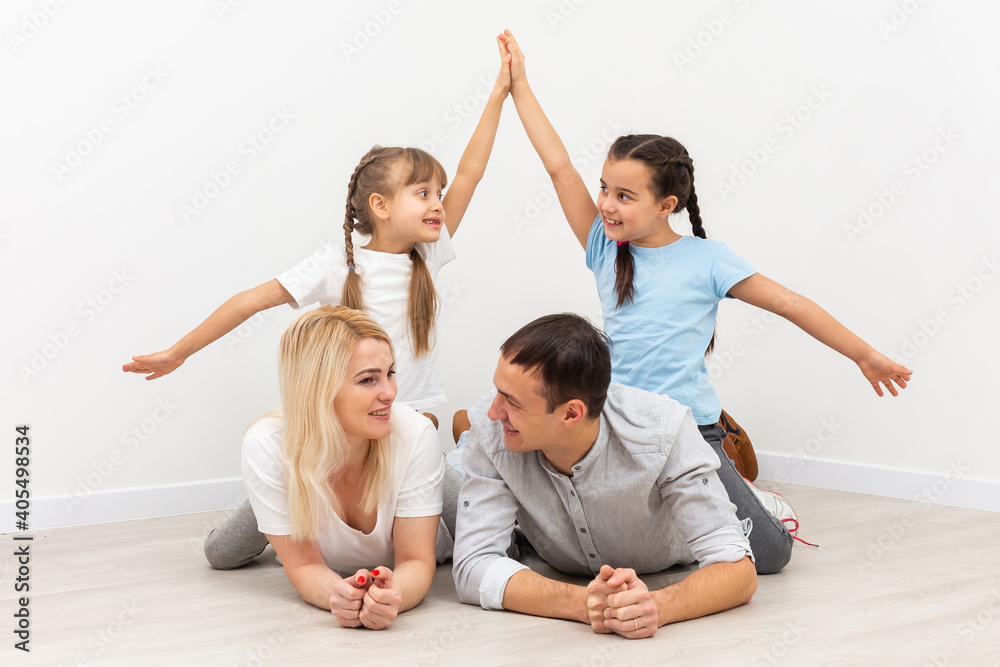concept housing a young family. Mother father and children in new house with a roof