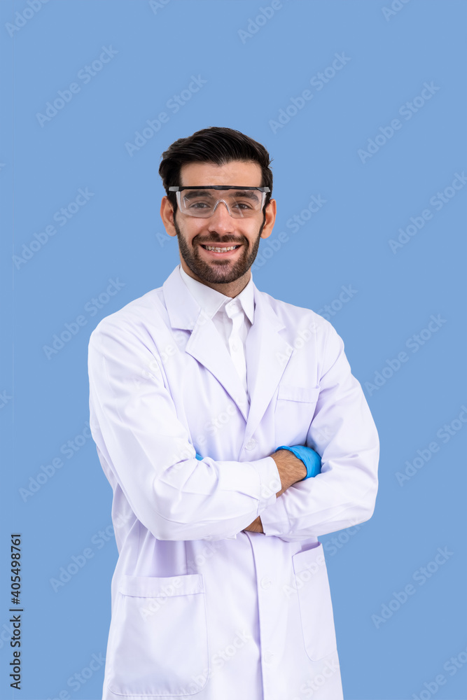 Portrait of confident male Middle Eastern Arab researcher scientist medical doctor wearing protection glasses standing cross arms isolated on light blue background Portrait of confident male Middle Eastern Arab researcher scientist medical doctor wearing protection glasses standing cross arms isolated on light blue background