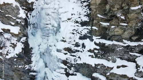 Wallpaper Mural Aerial drone video footage of partially frozen waterfall, located in italian Alps, with flowing water and fresh snow. Torontodigital.ca