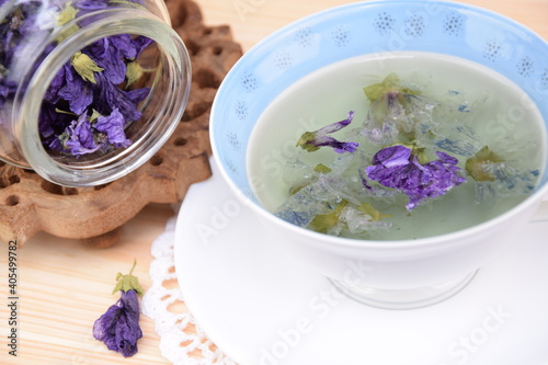 Mallow tea, herbal tea with dried mallow flowers in cup