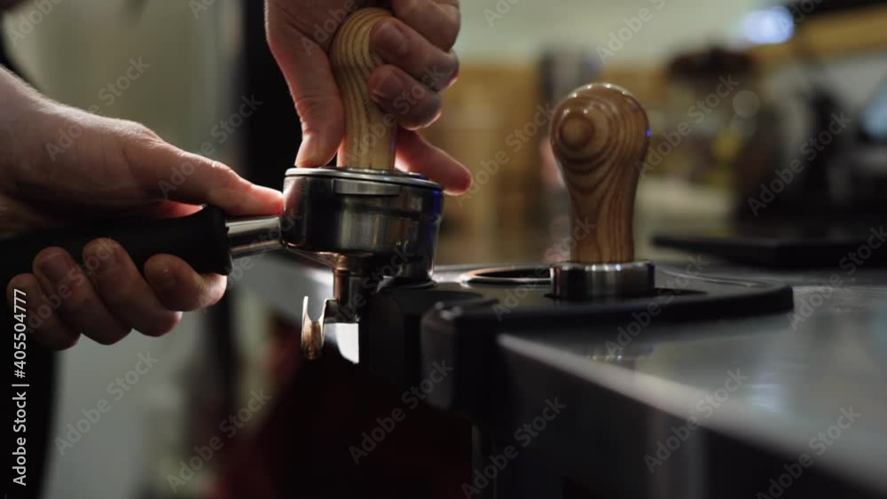 Preparing ground coffee with fresh coffee tamping. Close-up. Tamping freshly ground coffee. Professional barista. Preparing ground coffee with fresh coffee tamping. Close-up. Tamping freshly ground coffee. Professional barista.