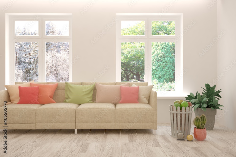 Fototapeta premium White living room with sofa, summer and winter landscape in window. Scandinavian interior design. 3D illustration