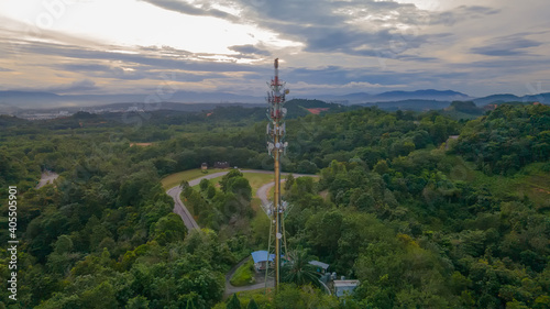 Aerial view of 5G Communication tower during beautiful sunrise with clouds