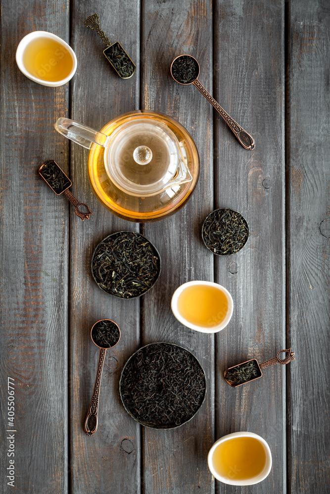 Tea ceremony concept. Hot and dry tea in teapot and cups, top view Tea ceremony concept. Hot and dry tea in teapot and cups, top view